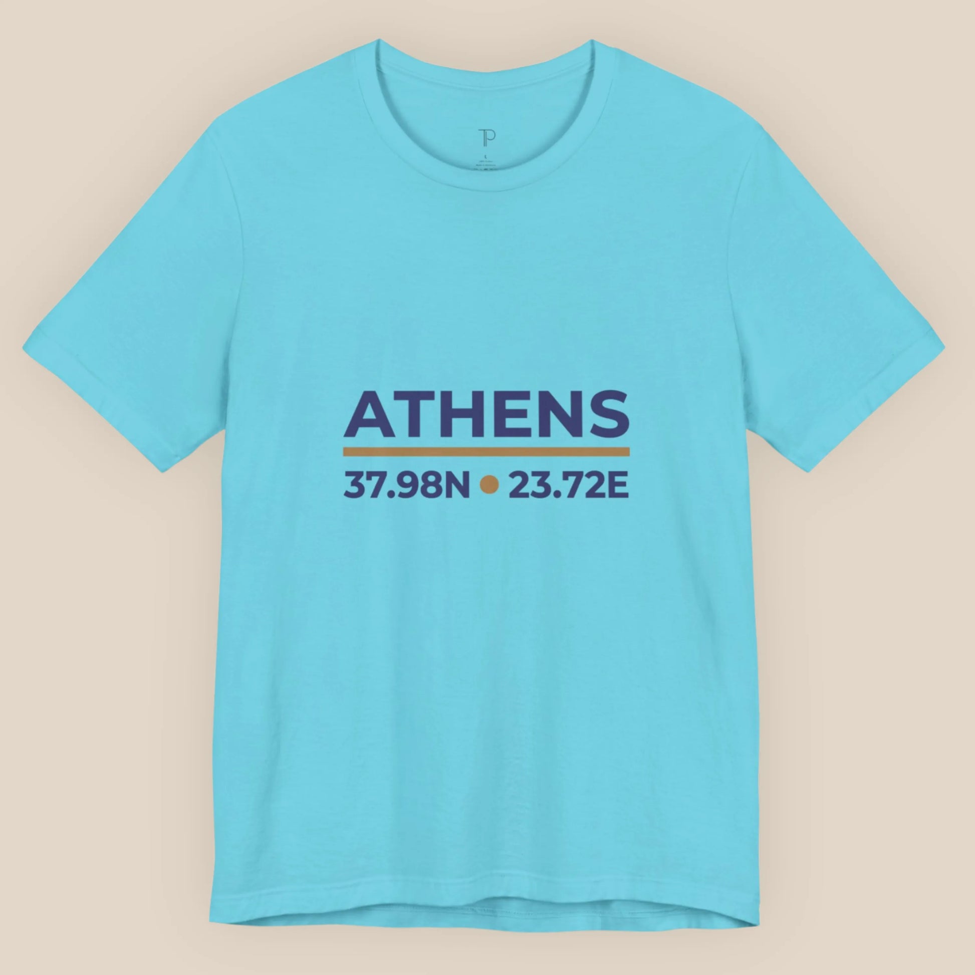Turquoise t-shirt with 'ATHENS' and coordinates printed on a beige background