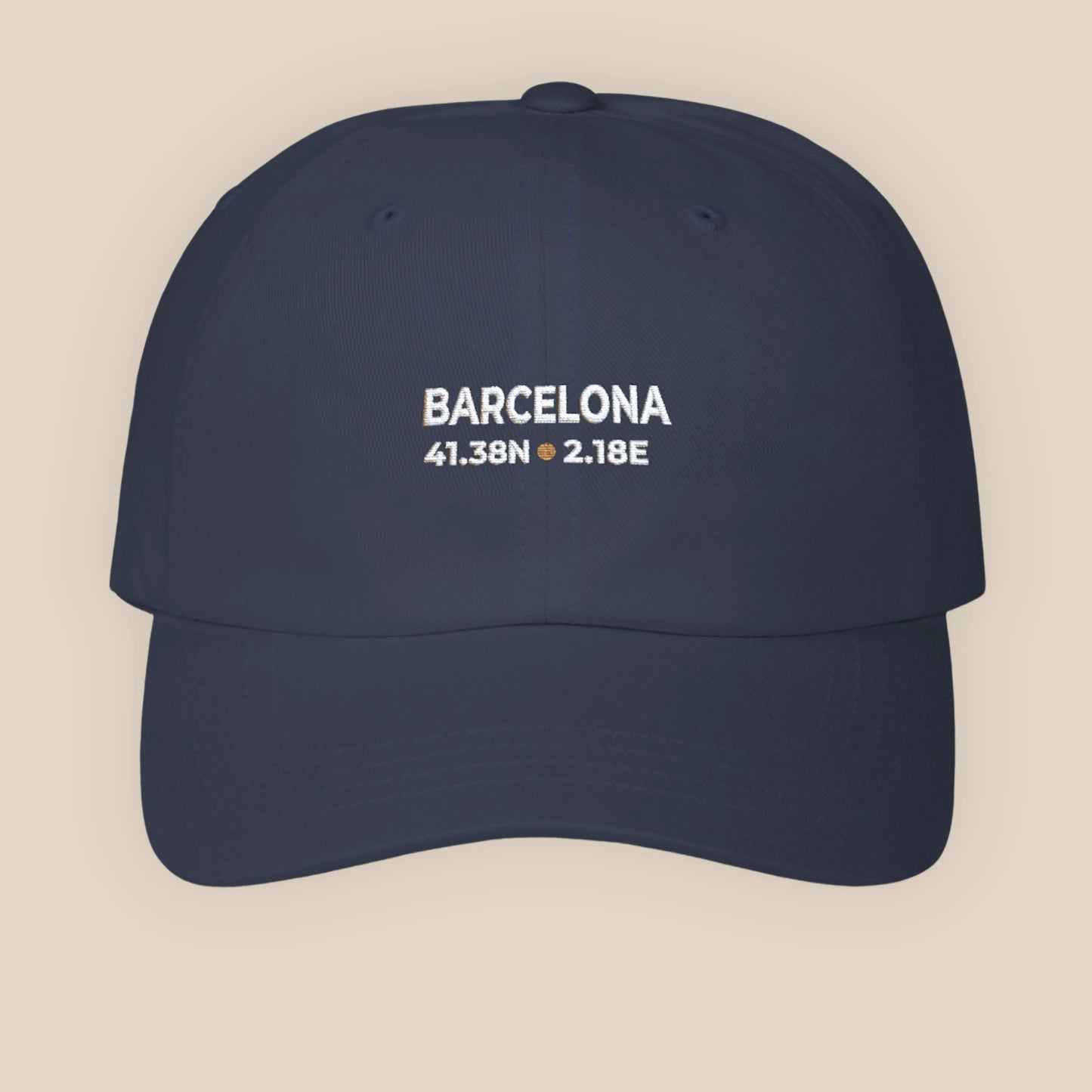 Navy blue cap with 'Barcelona' and coordinates on a beige background