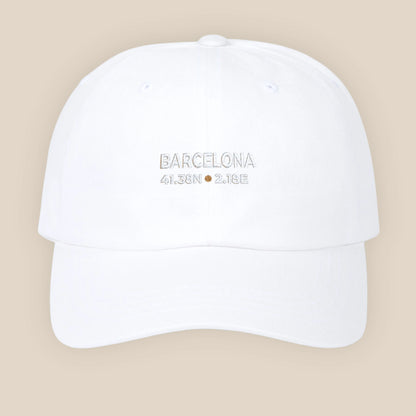 White cap with 'Barcelona, Spain' text on a beige background