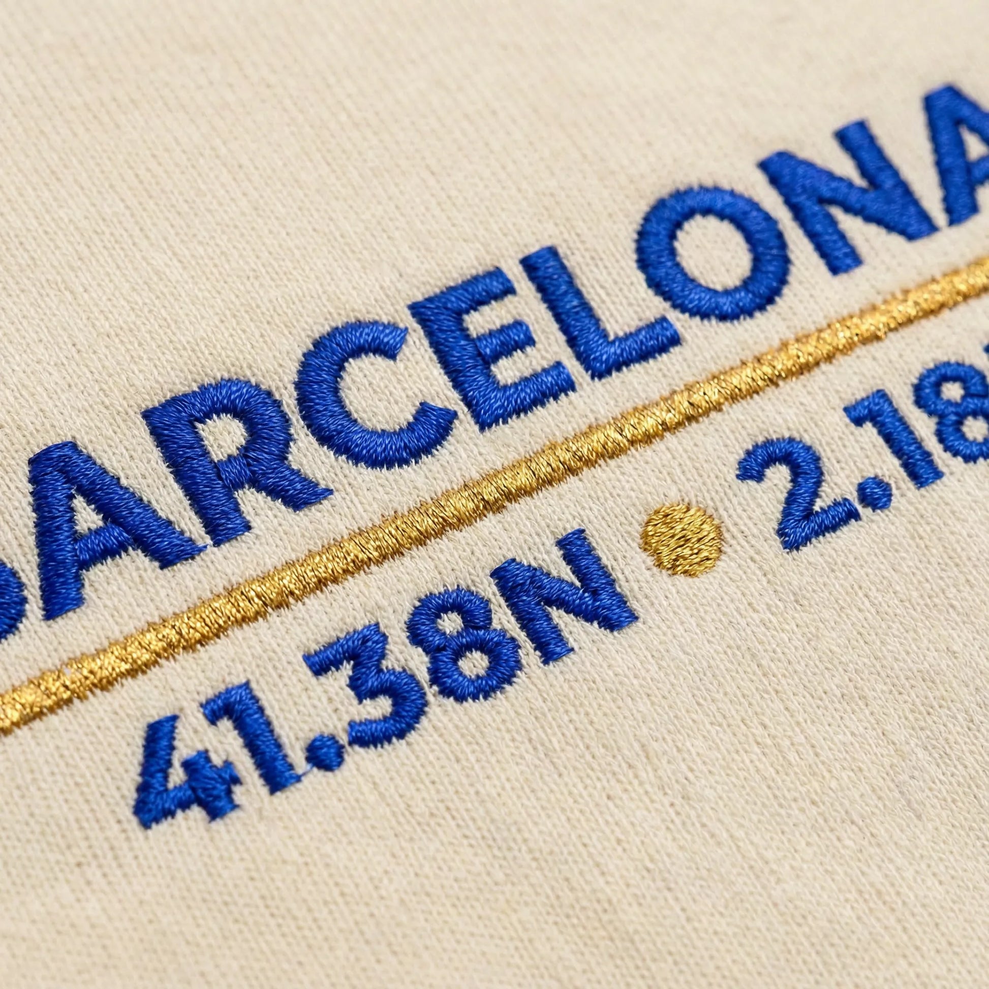 Macro close-up of Barcelona coordinates embroidery stitches on sweatshirt