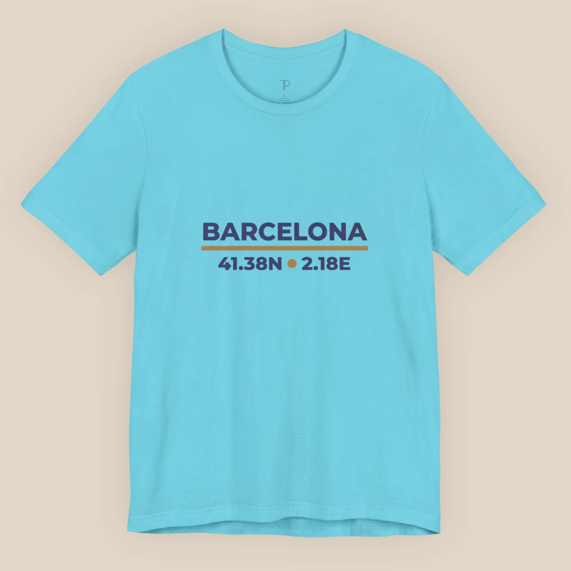 Light blue t-shirt with 'Barcelona' and coordinates printed on a beige background