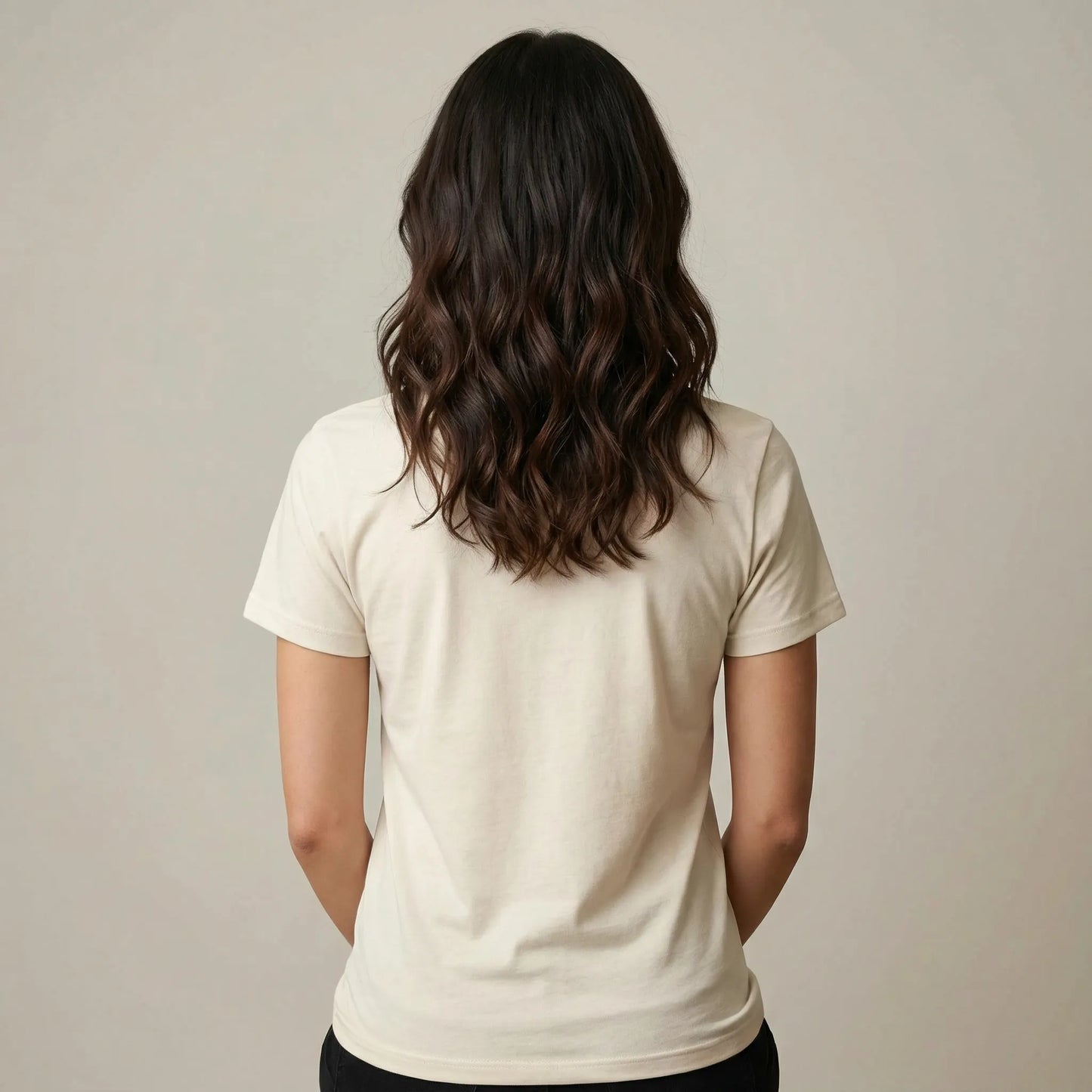 Person wearing a beige t-shirt against a plain background
