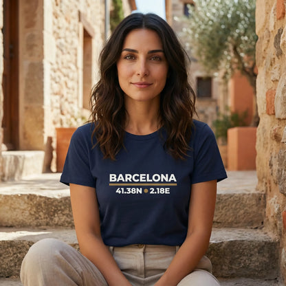 Woman wearing a navy blue t-shirt with 'Barcelona' and coordinates, sitting outdoors.
