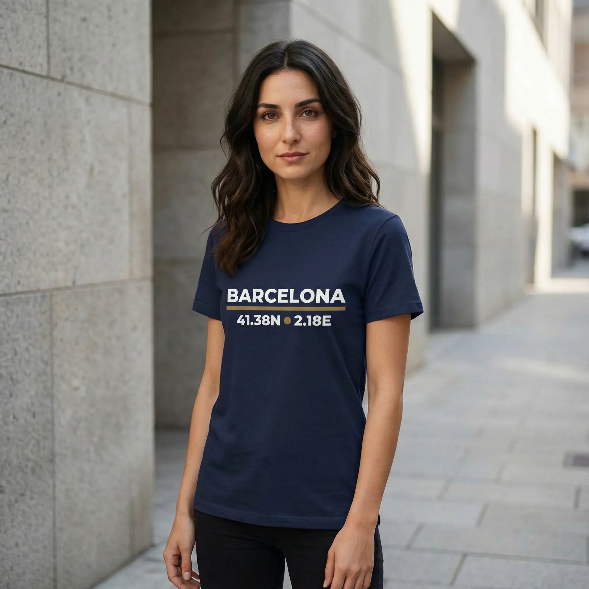 Woman wearing a navy blue t-shirt with 'Barcelona' and coordinates printed on it, standing in an urban setting.