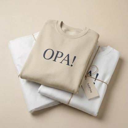 Folded sand Celebratory OPA crewneck sweatshirt with OPA print visible and minimal ToldPrint packaging