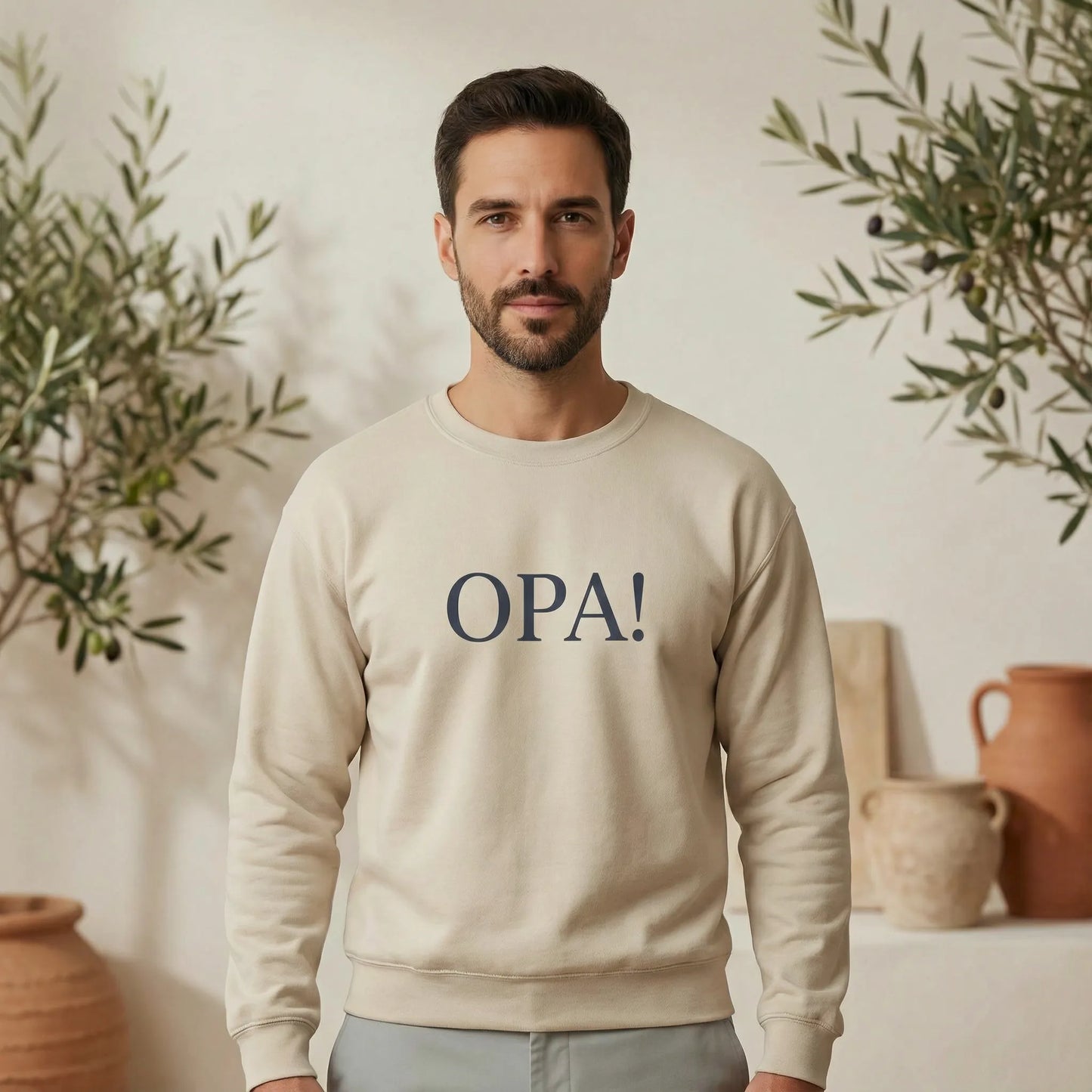 Unisex model wearing Celebratory OPA crewneck sweatshirt on an evening Mediterranean street walk