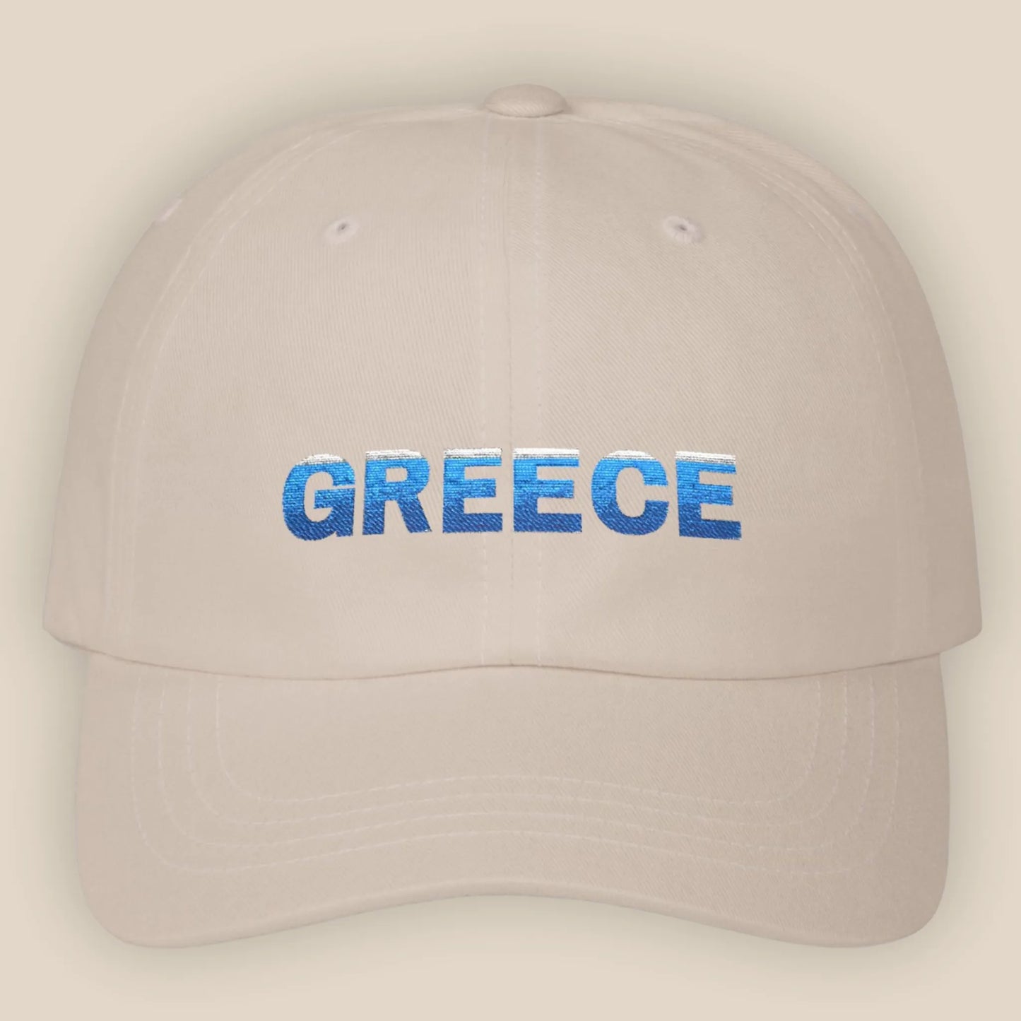 Flat lay of sand Greece Classic embroidered cotton dad cap showing Greece text on front panel