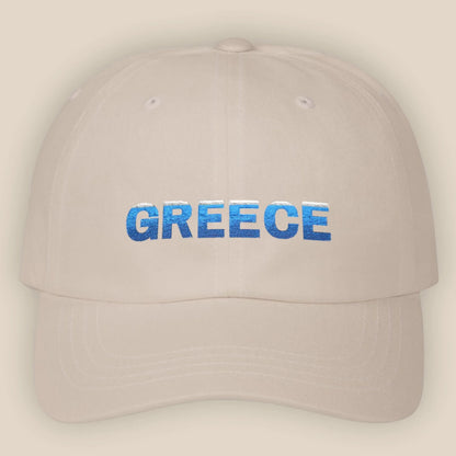 Flat lay of sand Greece Classic embroidered cotton dad cap showing Greece text on front panel
