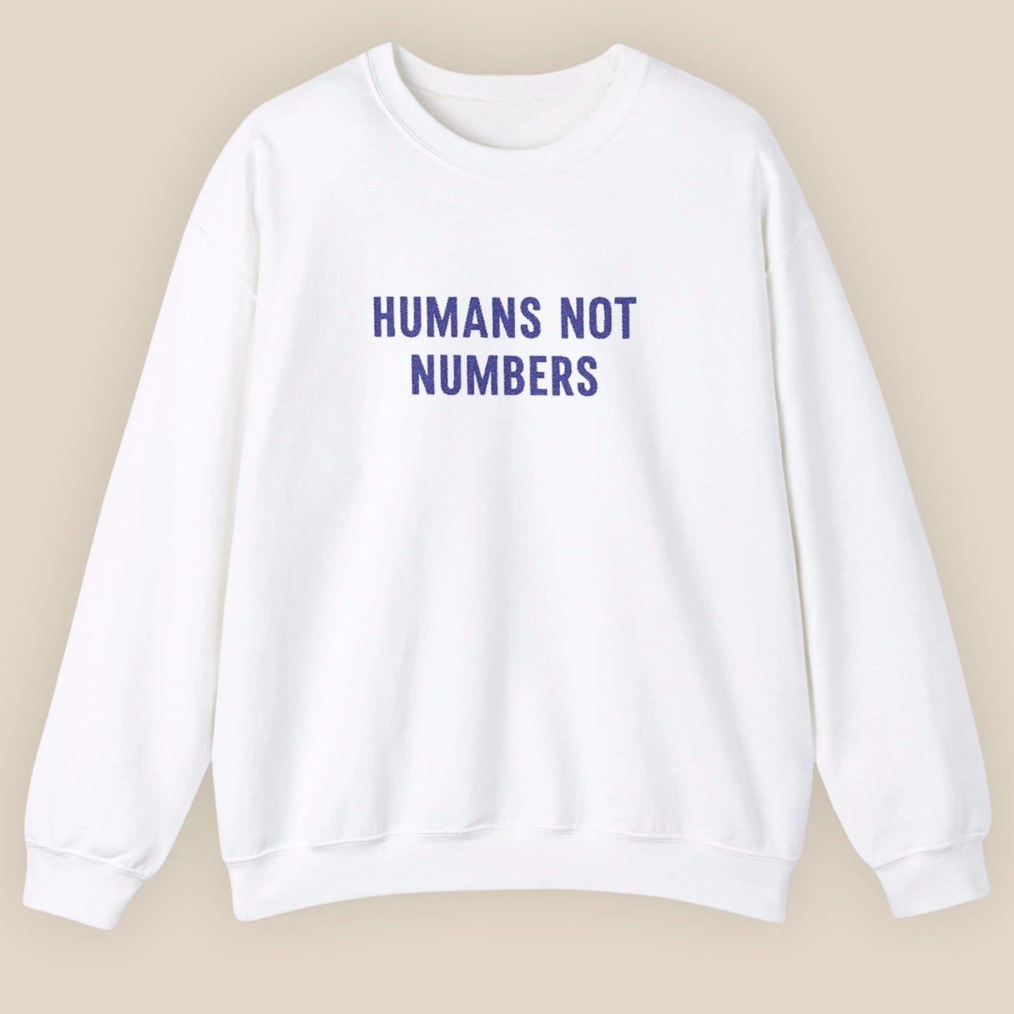 Flat lay of Humans Not Numbers embroidered sweatshirt in white