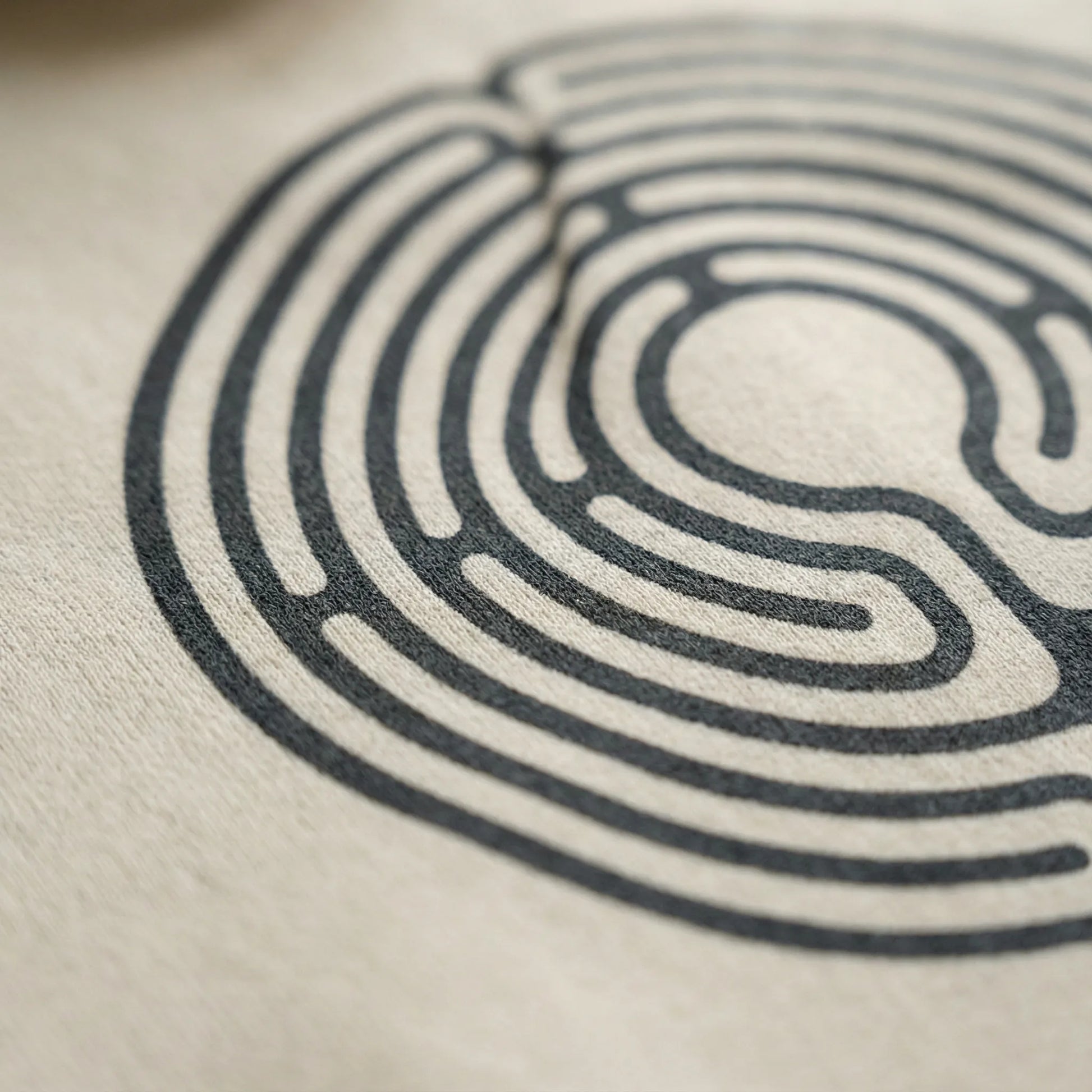 Close-up of DTG circular labyrinth print detail on fleece fabric