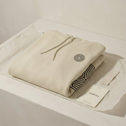 Folded Labyrinth Hoodie with visible labyrinth motif and minimal ToldPrint packaging