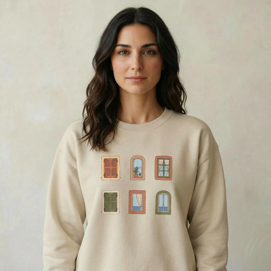 TP:HERO Woman wearing a beige sweatshirt with window design on a plain background
