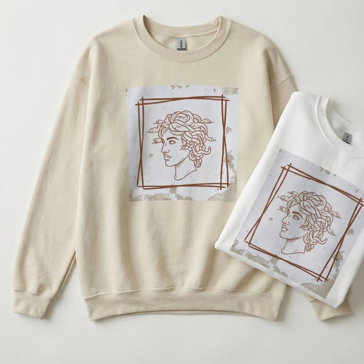 lat lay of Minimal Medusa sweatshirt in Sand and White colorways