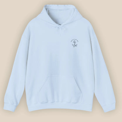 Flat lay of Monk Seal Embrace hoodie in light blue colour with ocean conservation design