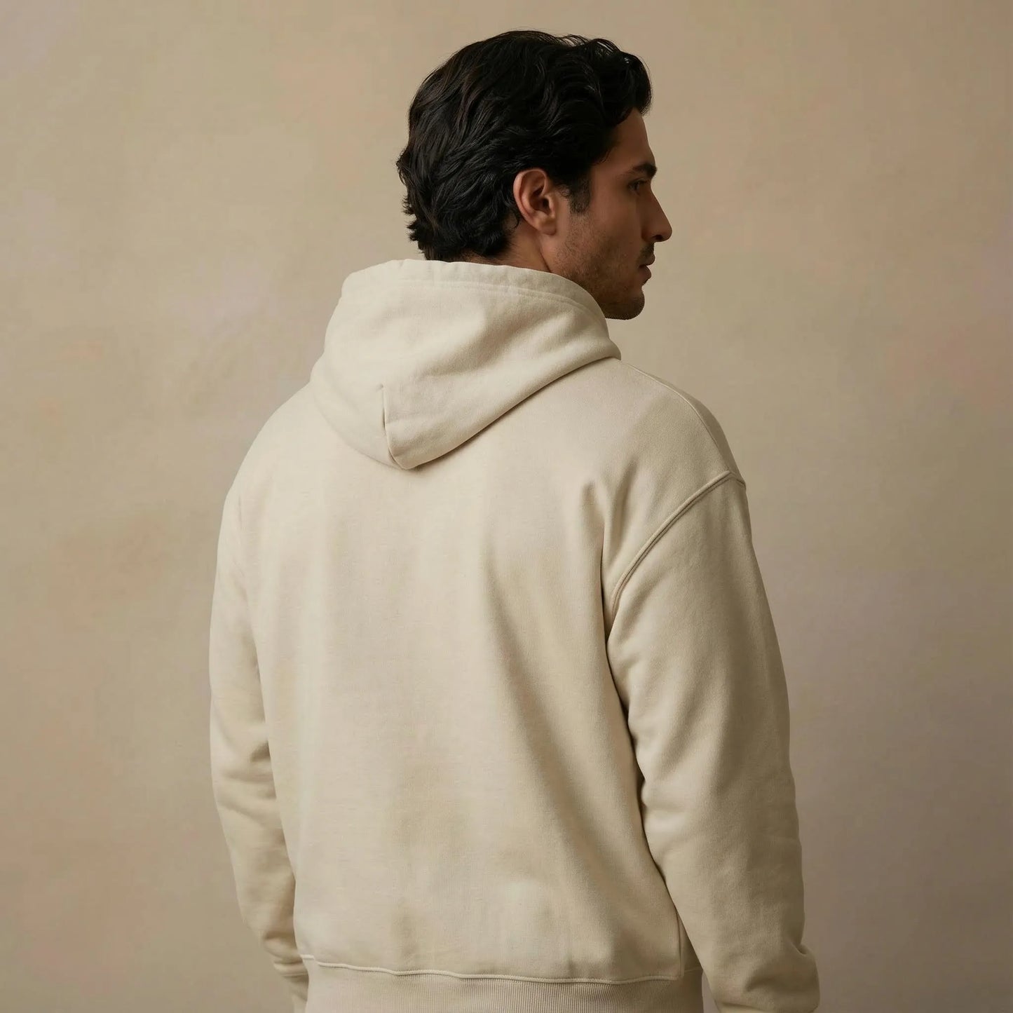 Three-quarter back studio view showing fit and hood of Pomos Idol hoodie