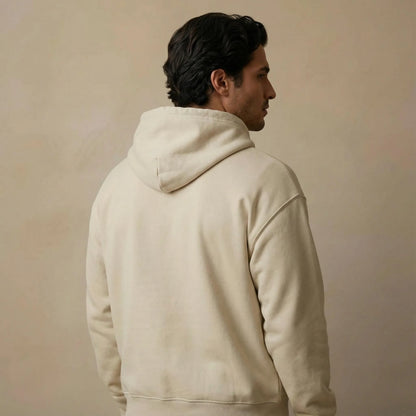 Three-quarter back studio view showing fit and hood of Pomos Idol hoodie