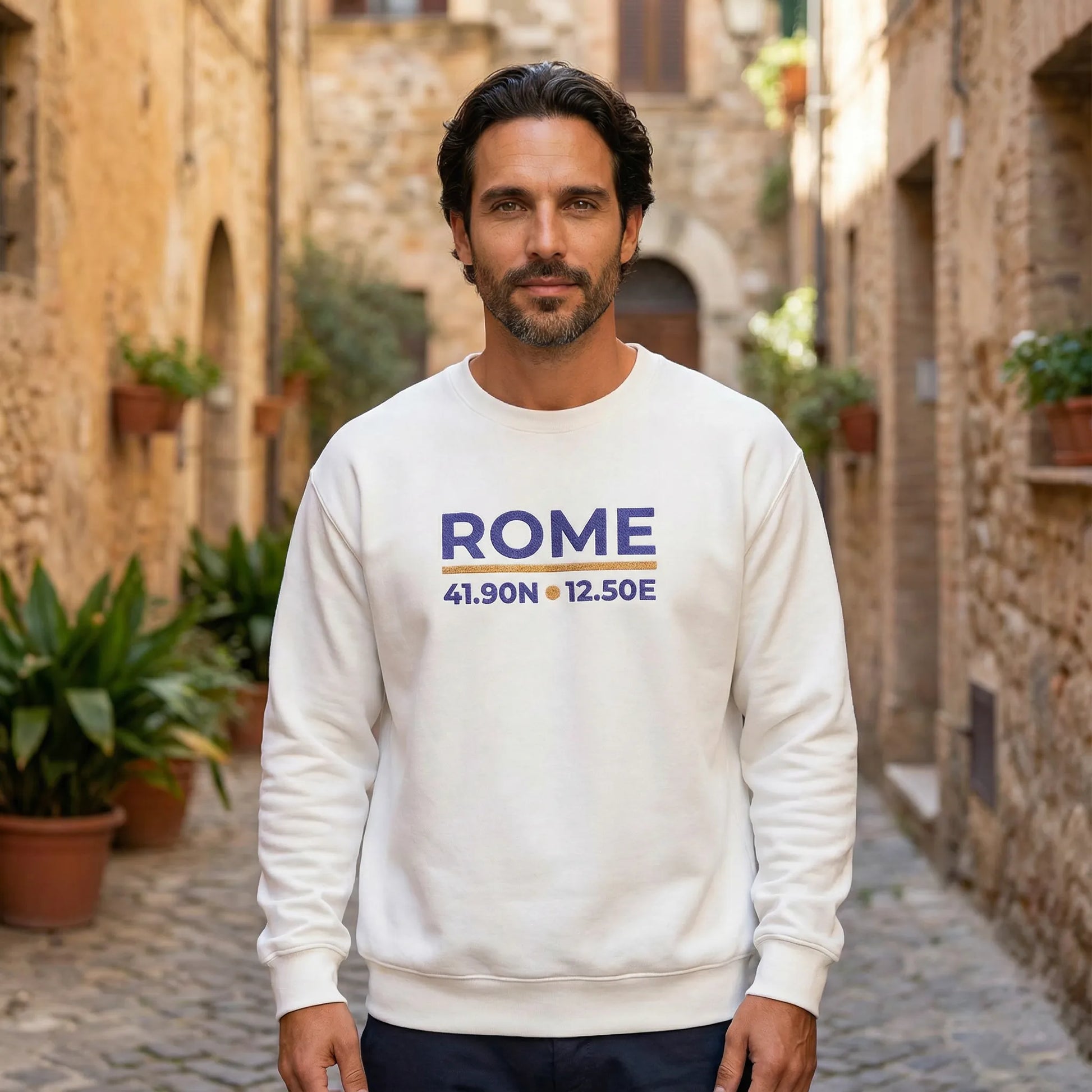 Rome coordinates embroidered sweatshirt worn outdoors in Mediterranean street setting