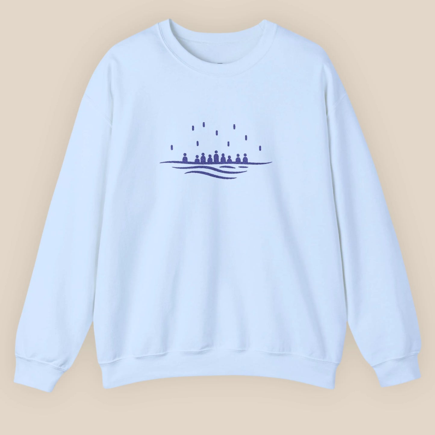 Flat lay of light blue embroidered crewneck sweatshirt with minimalist sea design, unisex fit