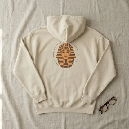Flat lay of sand Sphinx graphic hoodie showing centred back Sphinx badge on neutral background