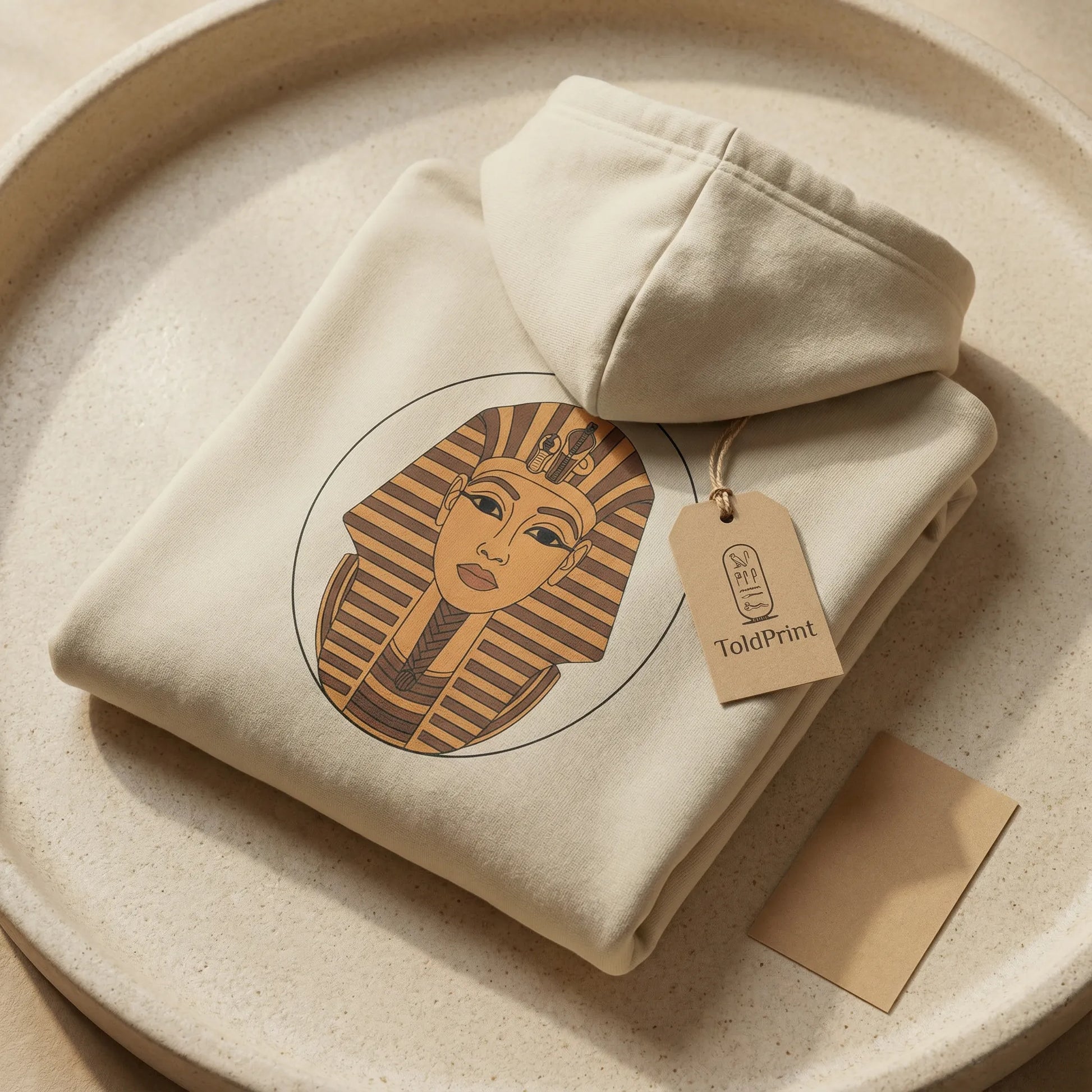 Folded Sphinx graphic hoodie in sand colour with ToldPrint branding and minimal packaging ready for shipping