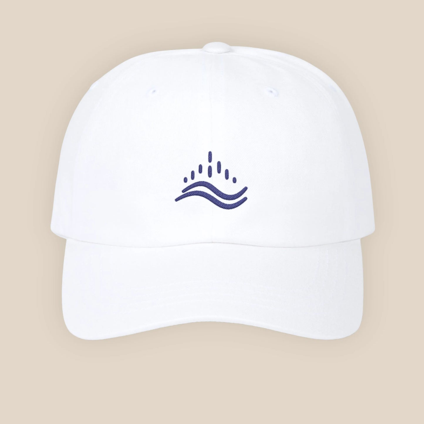 White embroidered dad cap, navy wave emblem, adjustable strap, clean studio set.