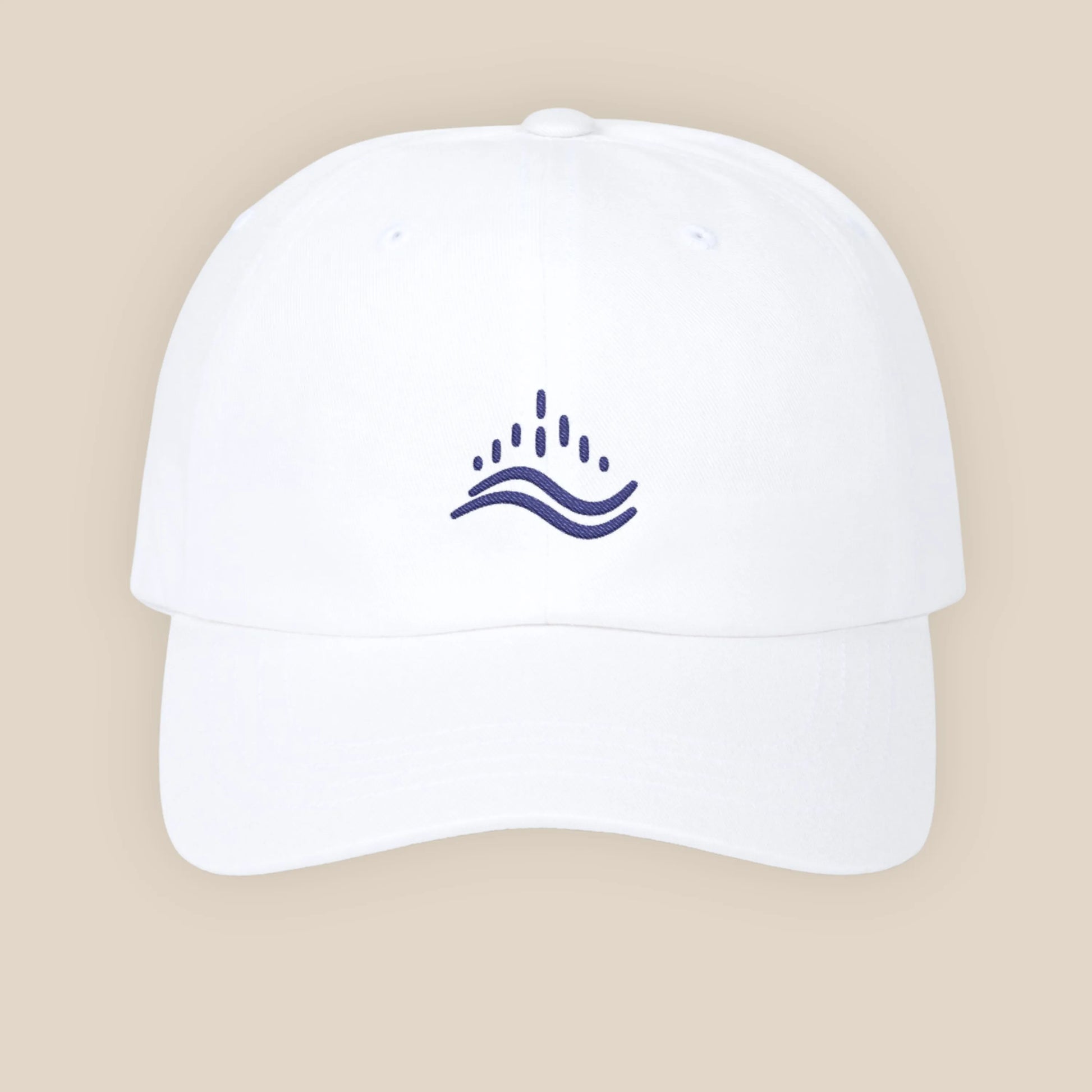 White embroidered dad cap, navy wave emblem, adjustable strap, clean studio set.