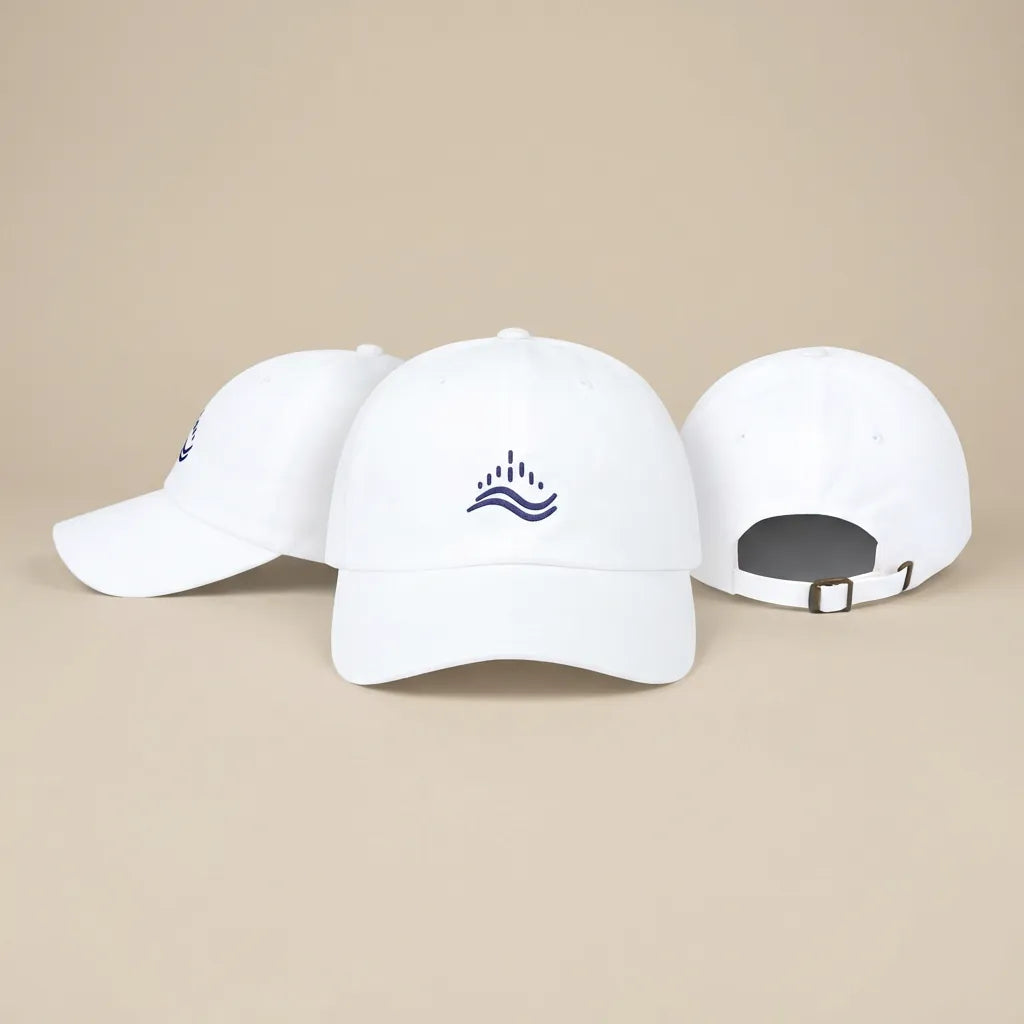 White embroidered dad cap shown in three angles (front, side, back), navy wave emblem, adjustable strap, clean studio set.