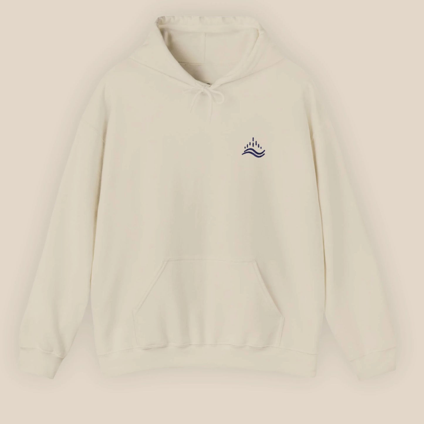 Sand unisex hoodie with small navy waves emblem embroidered on the left chest, photographed front view in a beige background