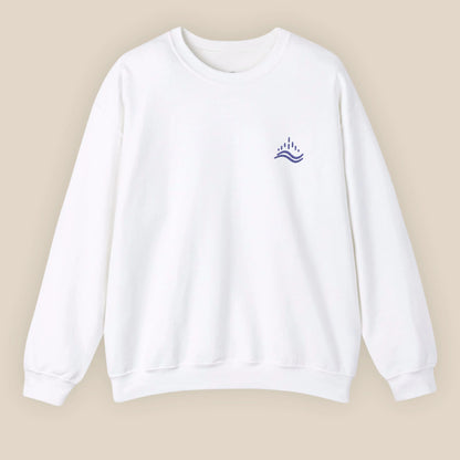 White unisex sweatshirt with navy waves emblem embroidered on the left chest, photographed flat in a neutral studio.