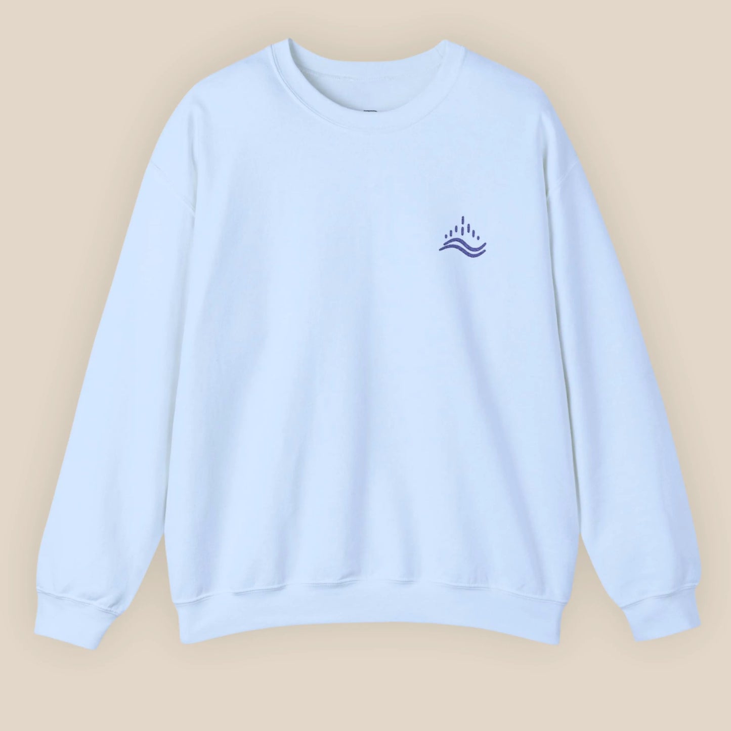 Light blue unisex sweatshirt with navy waves emblem embroidered on the left chest, photographed flat in a neutral studio.
