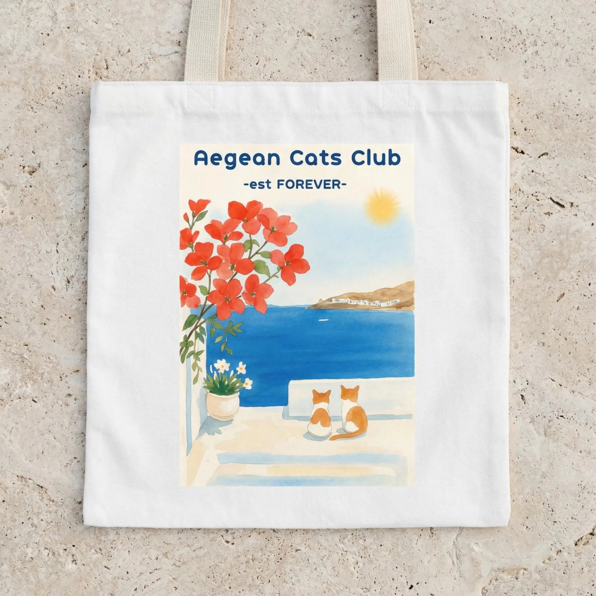 Flat lay of Aegean Cats Club canvas tote bag with coastal cat design