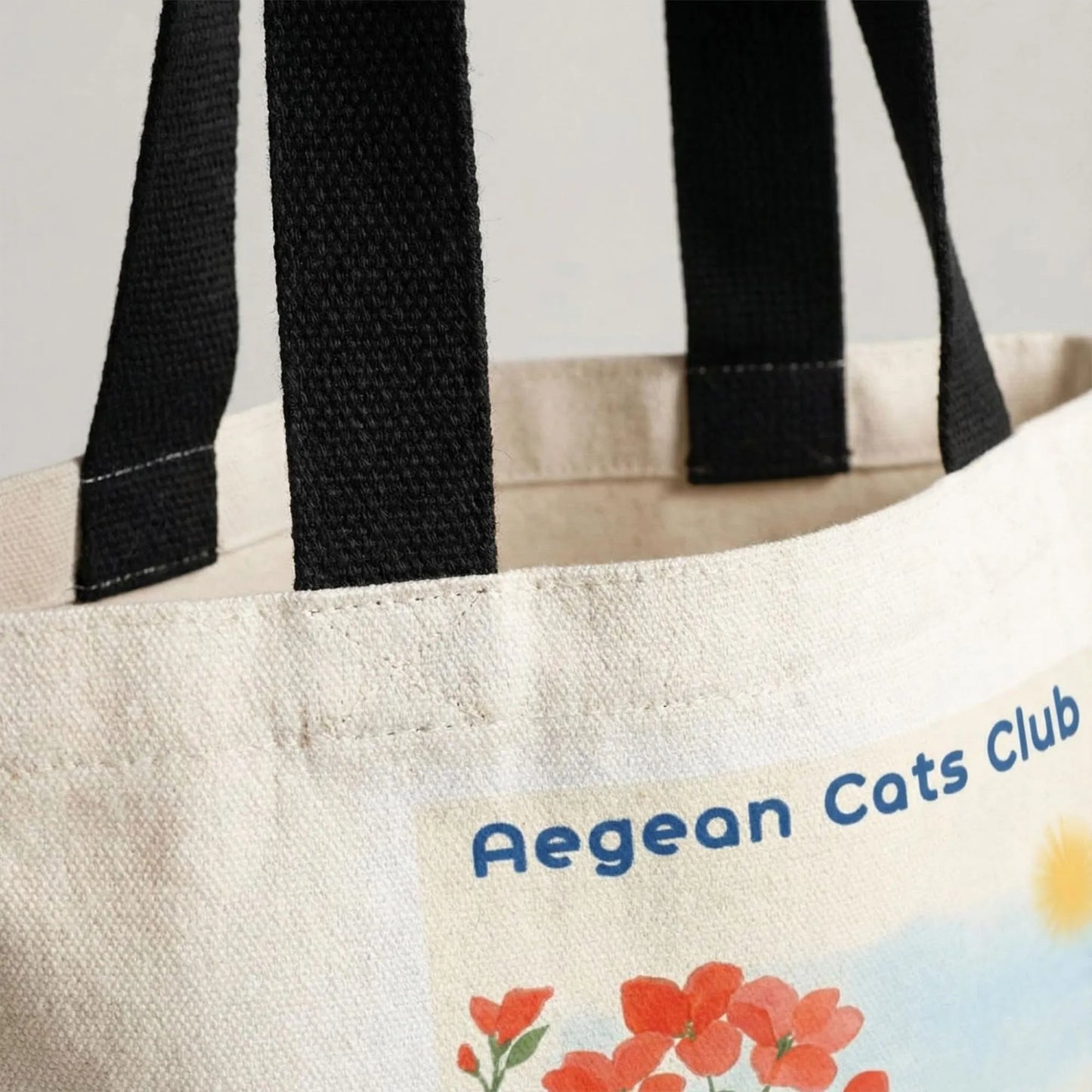 Close-up of Aegean Cats Club tote bag handles and cotton canvas texture