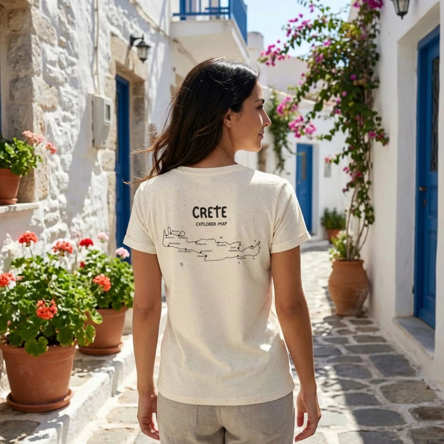 Explore Crete travel t-shirt styled on a model in a Mediterranean street