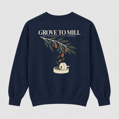 A navy blue crewneck sweatshirt featuring a graphic print of an olive branch with olives and a grinding mill, with the text 'GROVE TO MILL' and 'MEDITERRANEAN OLIVE HARVEST' printed above it.