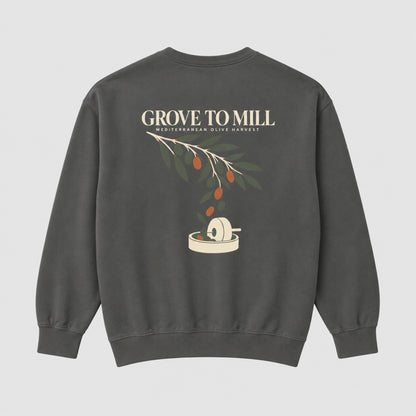 A dark gray crewneck sweatshirt shown from the back, featuring a graphic print of an olive branch with olives and a grinding mill, with the text 'GROVE TO MILL' and 'MEDITERRANEAN OLIVE HARVEST'.