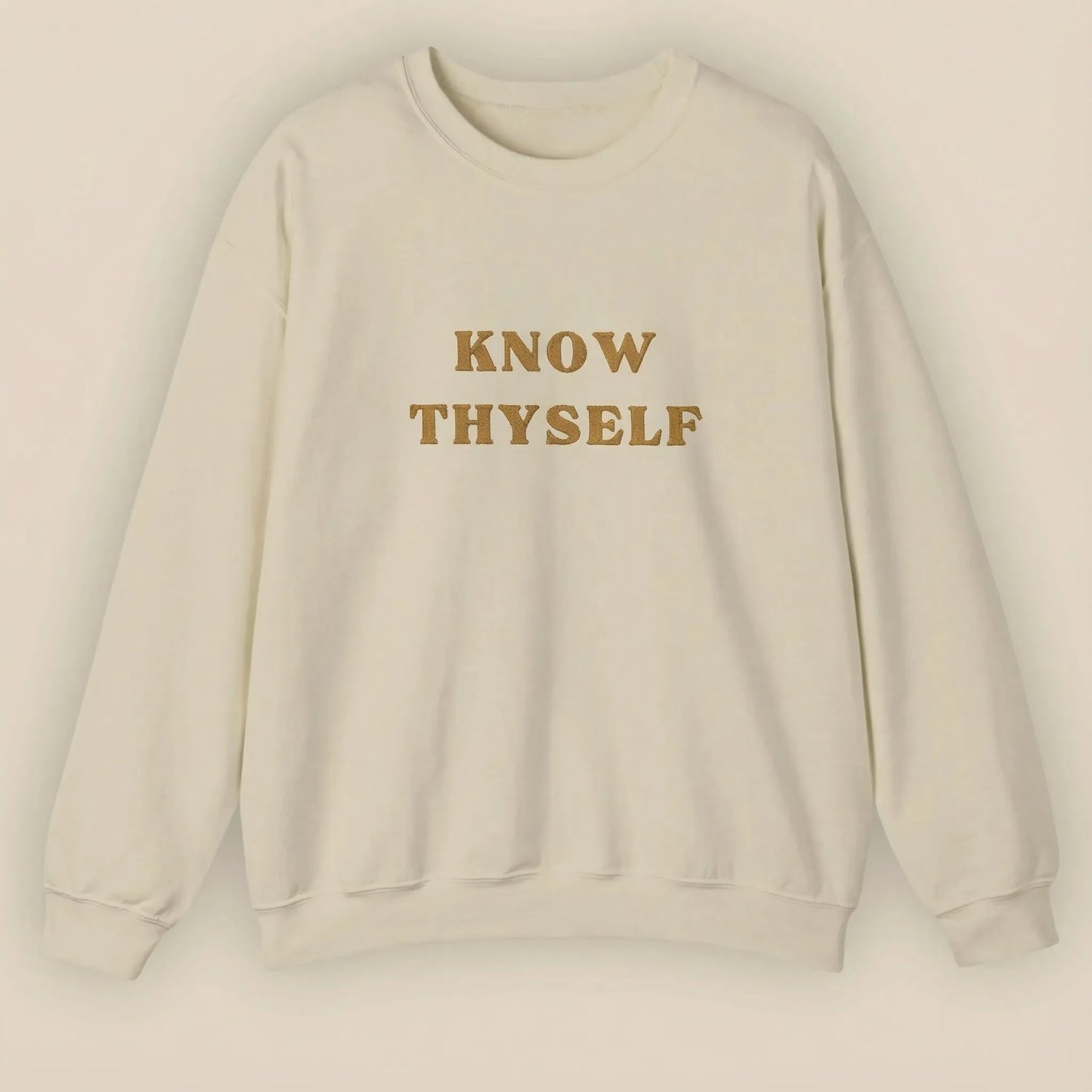 Beige sweatshirt with 'KNOW THYSELF' text on a beige background