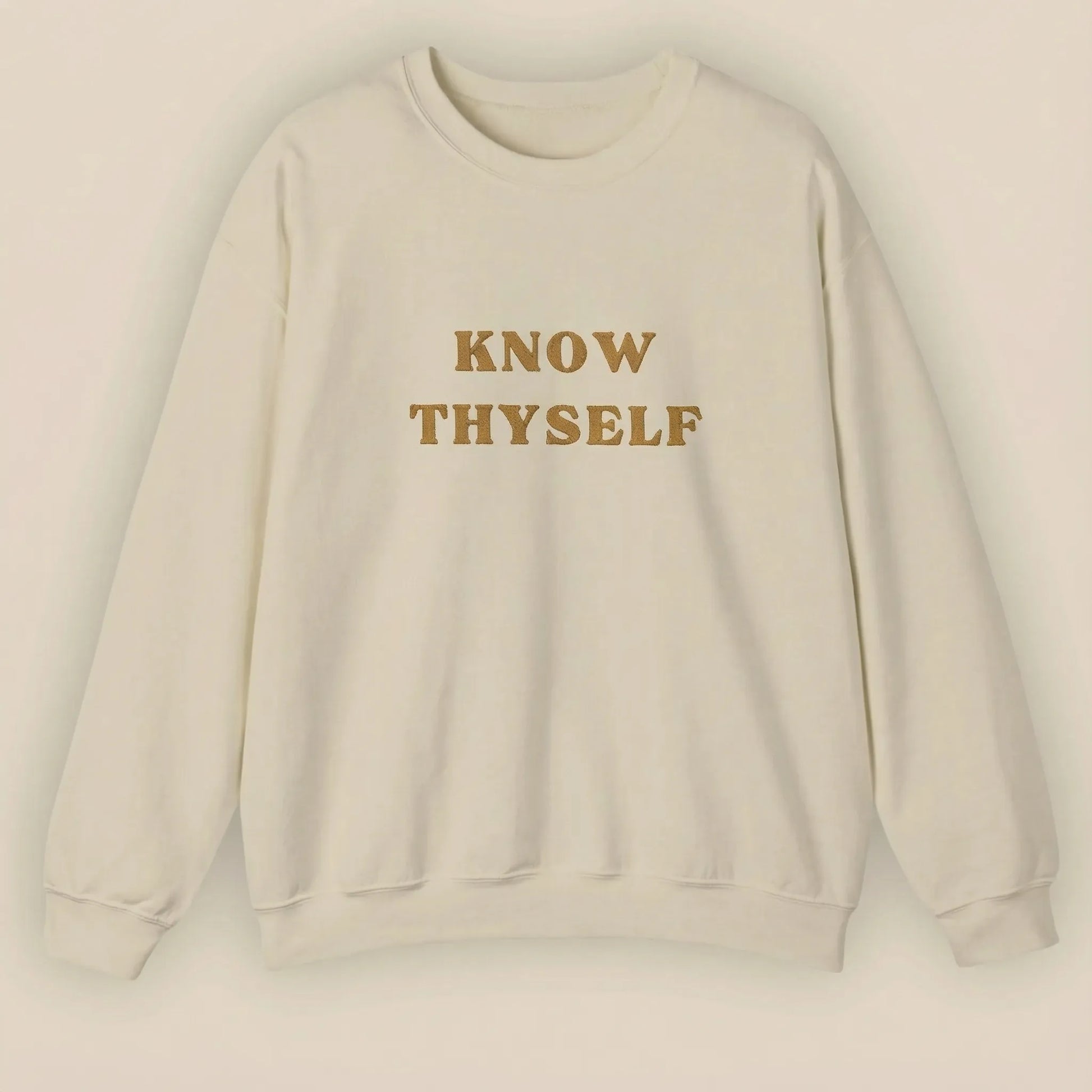 Beige sweatshirt with 'KNOW THYSELF' text on a beige background
