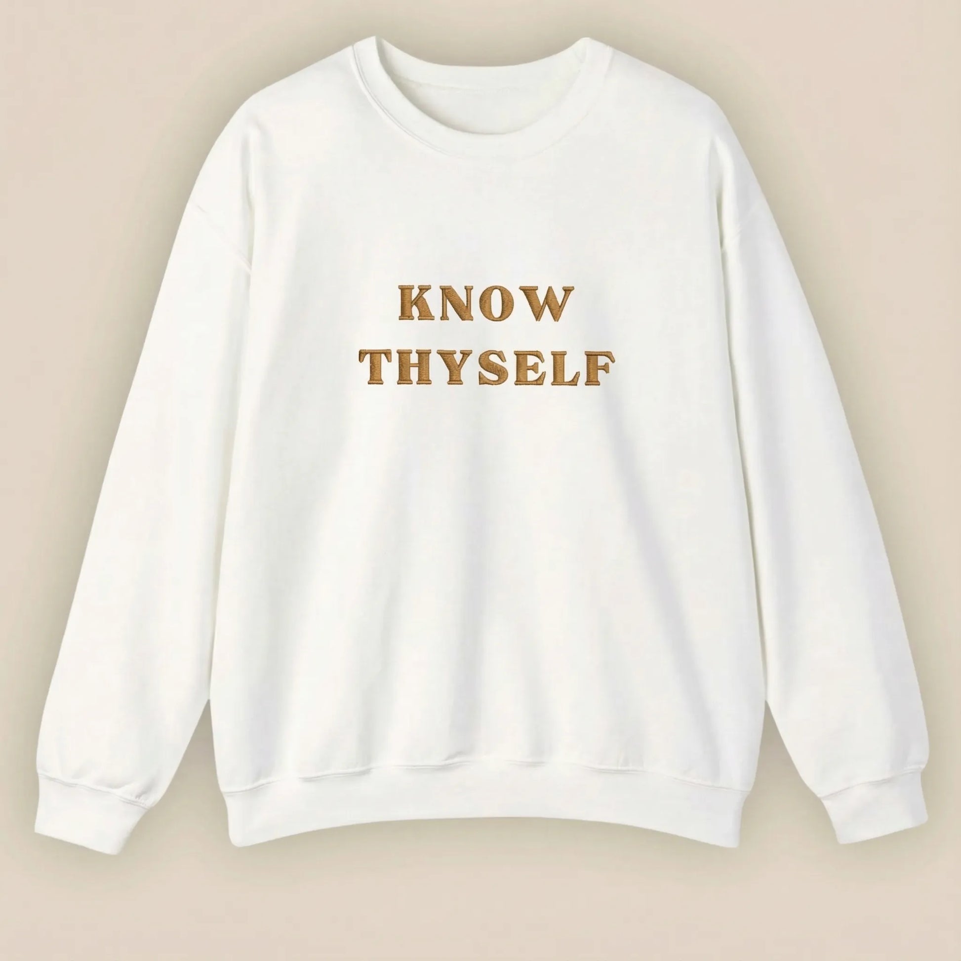 White sweatshirt with 'KNOW THYSELF' text on a beige background