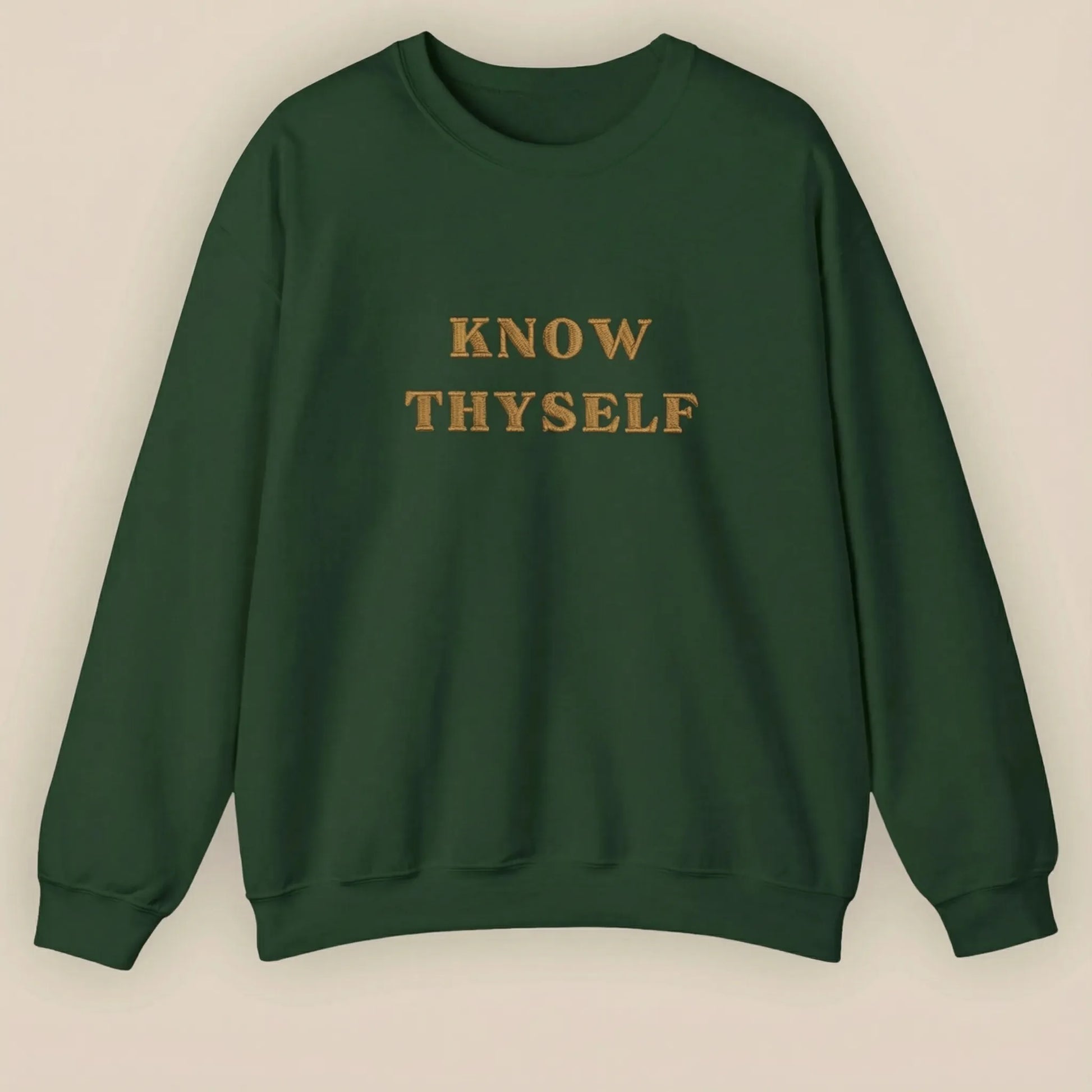 Green sweatshirt with 'KNOW THYSELF' text on a beige background