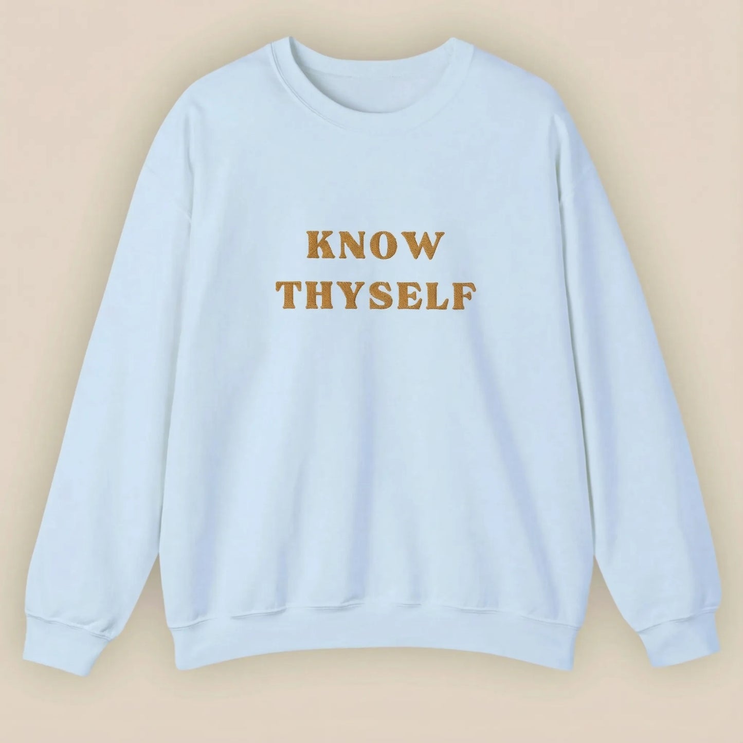 Light blue sweatshirt with 'KNOW THYSELF' text on a beige background