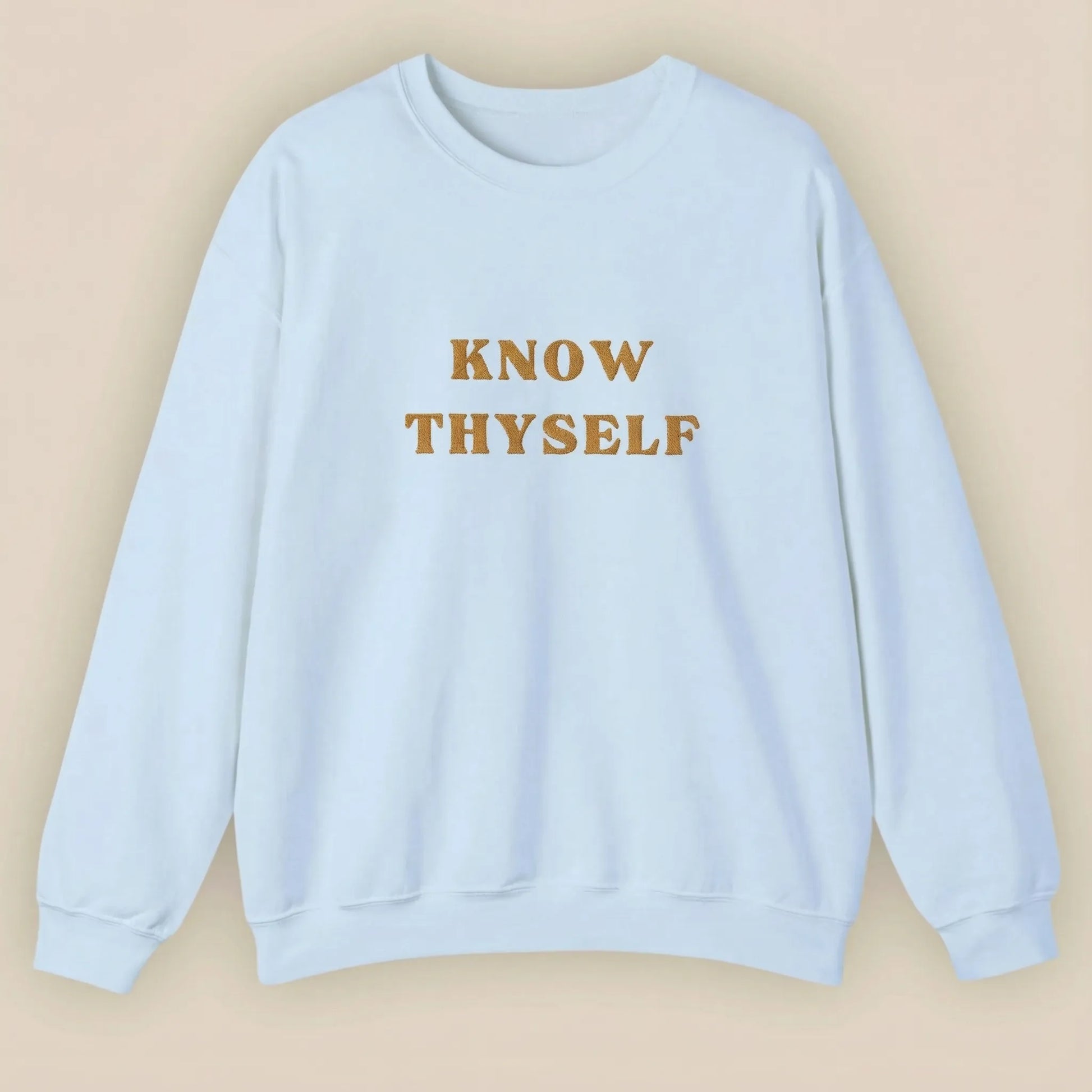 Light blue sweatshirt with 'KNOW THYSELF' text on a beige background