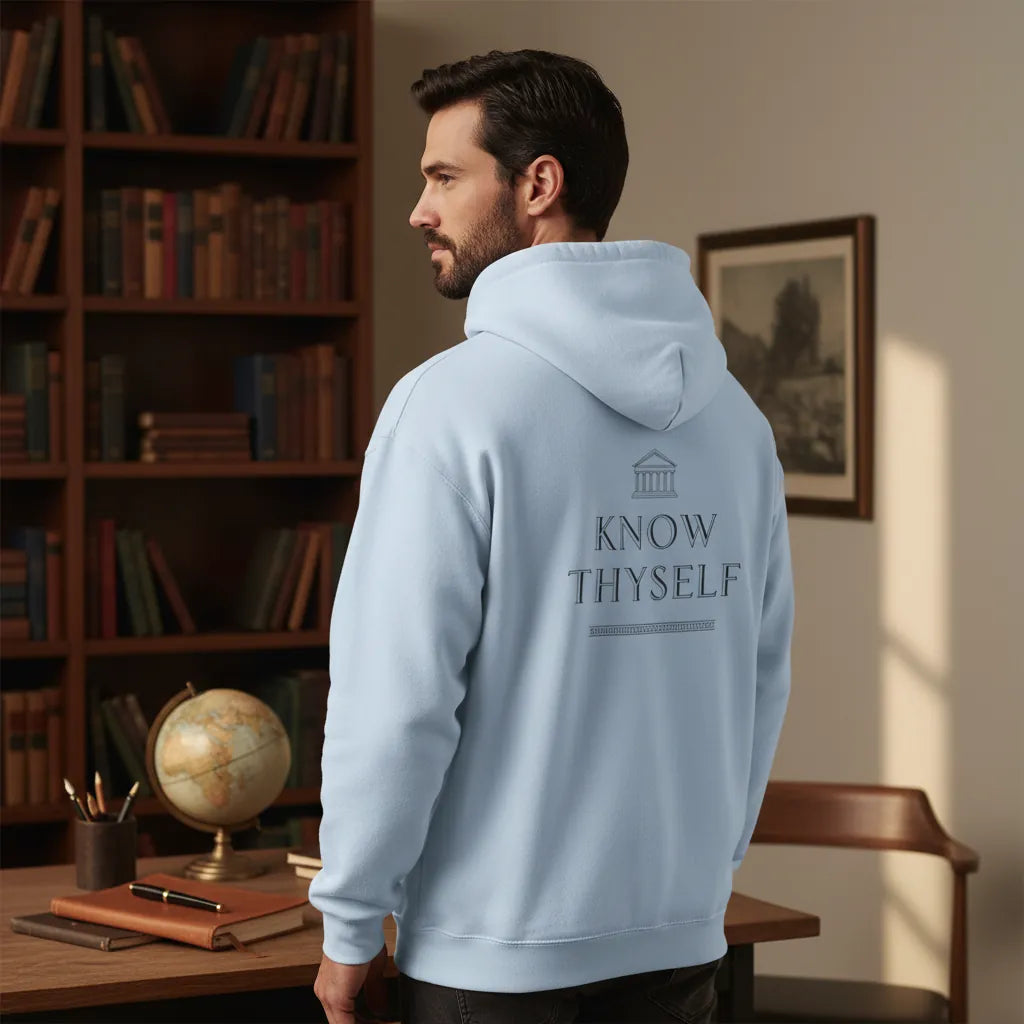 Know Thyself DTG hoodie in light blue shown from the back in a calm indoor reading setting
