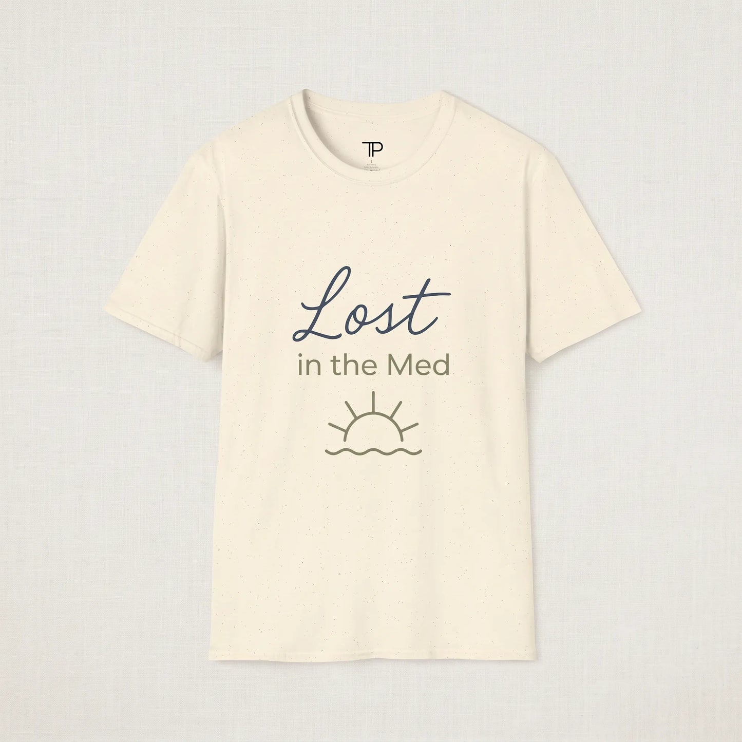 Beige t-shirt with 'Lost in the Med' text and sun graphic on a light gray background