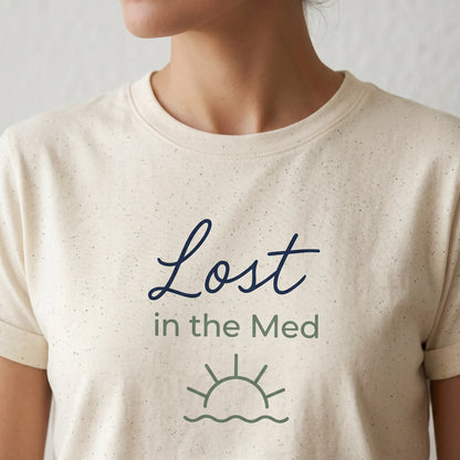 TP HERO: Beige t-shirt with 'Lost in the Med' text and sun/wave graphic on a plain background