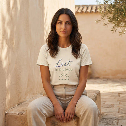 Woman wearing Lost in the Med Mediterranean T-shirt in a calm outdoor coastal setting