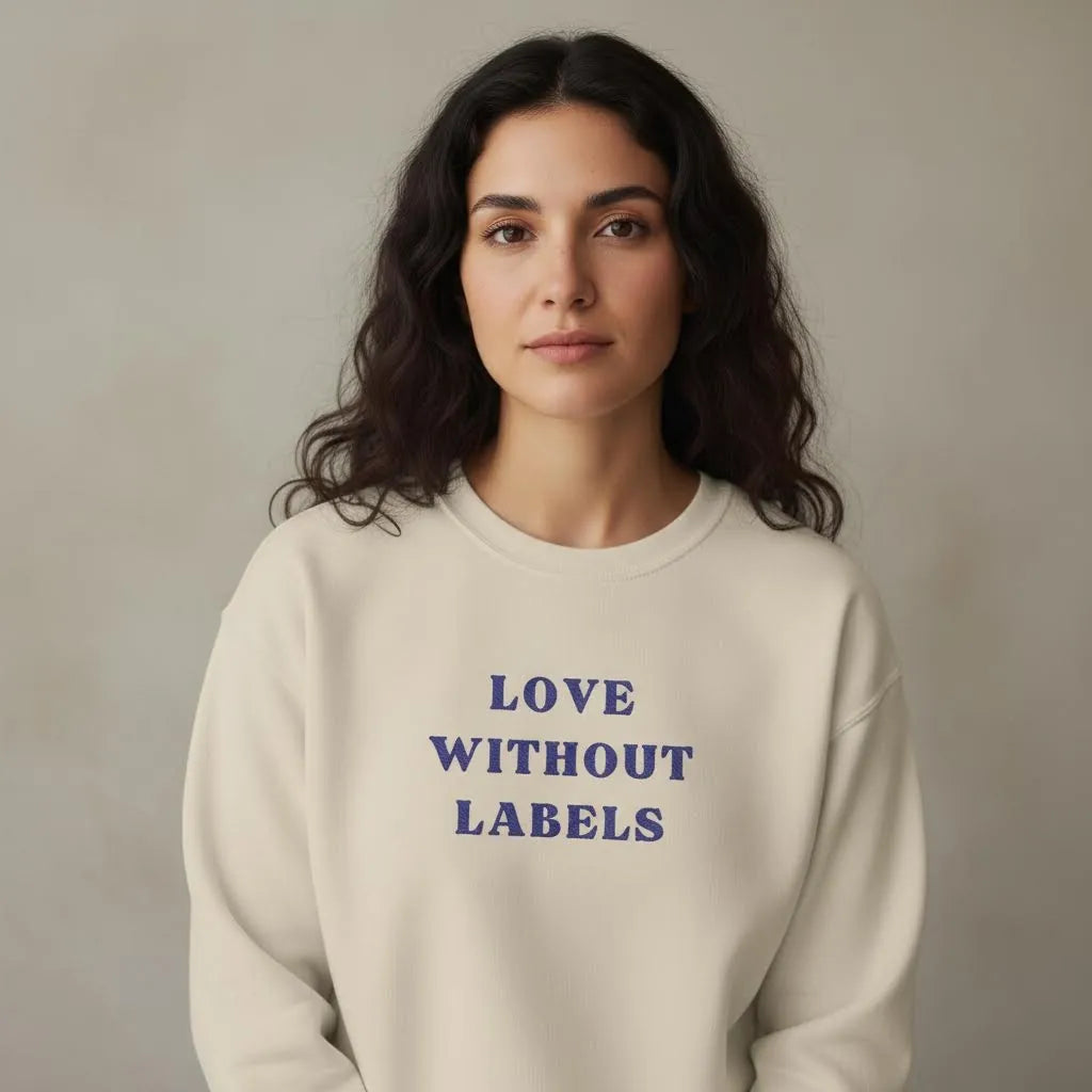 TP:HERO Model wearing Love Without Labels Greekify embroidered unisex sweatshirt by ToldPrint in a calm studio setting