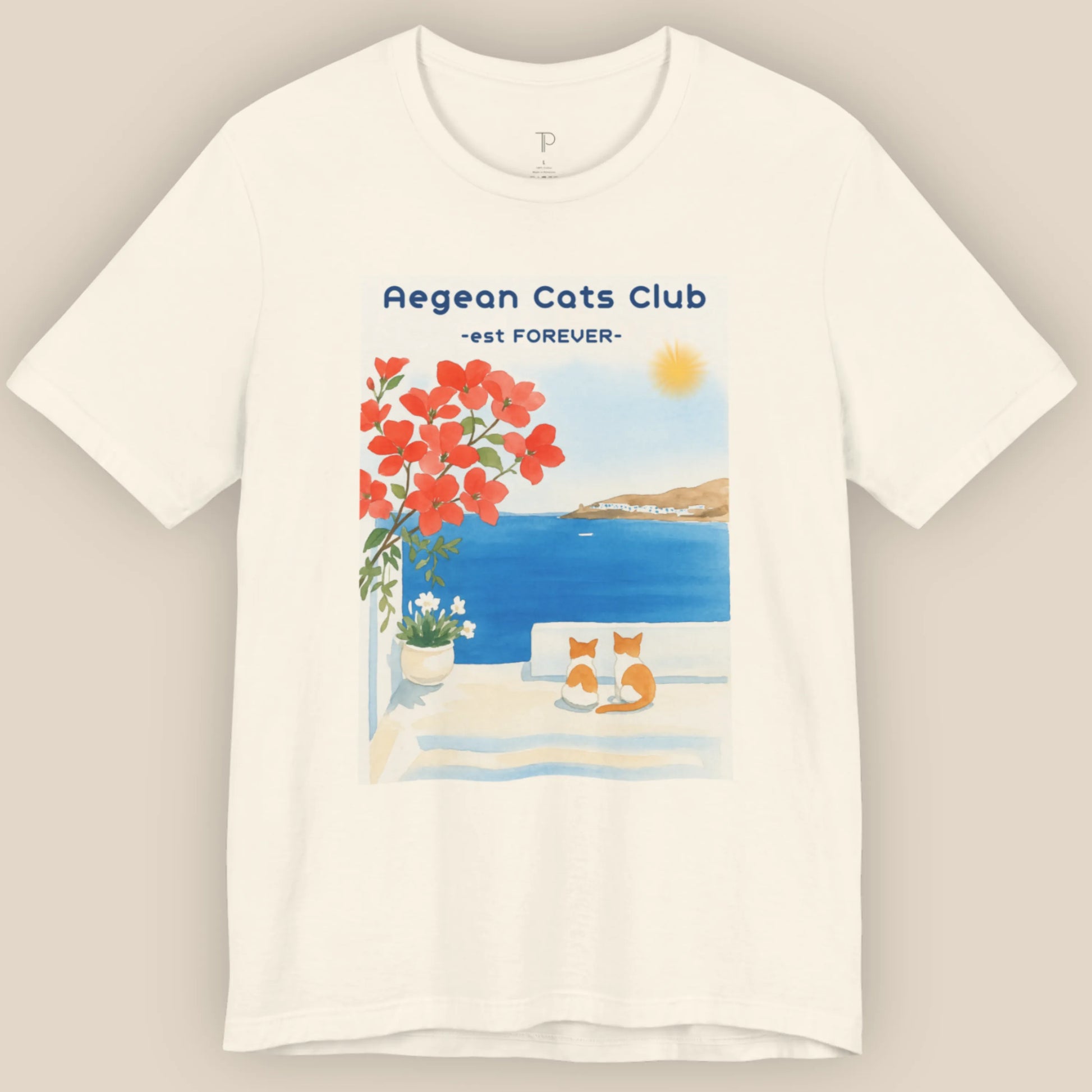 White t-shirt with Aegean Cats Club design featuring a cat, flowers, and a sunset.