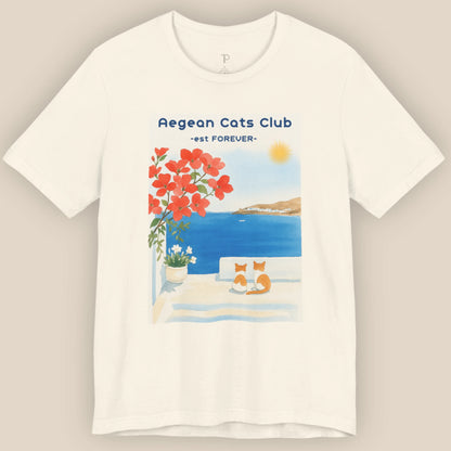 White t-shirt with Aegean Cats Club design featuring a cat, flowers, and a sunset.