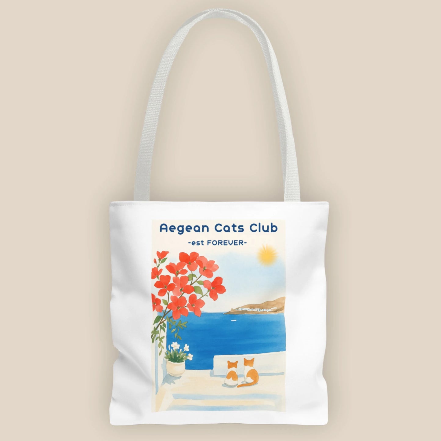 Tote bag with Aegean Cats Club design featuring a coastal scene and flowers.