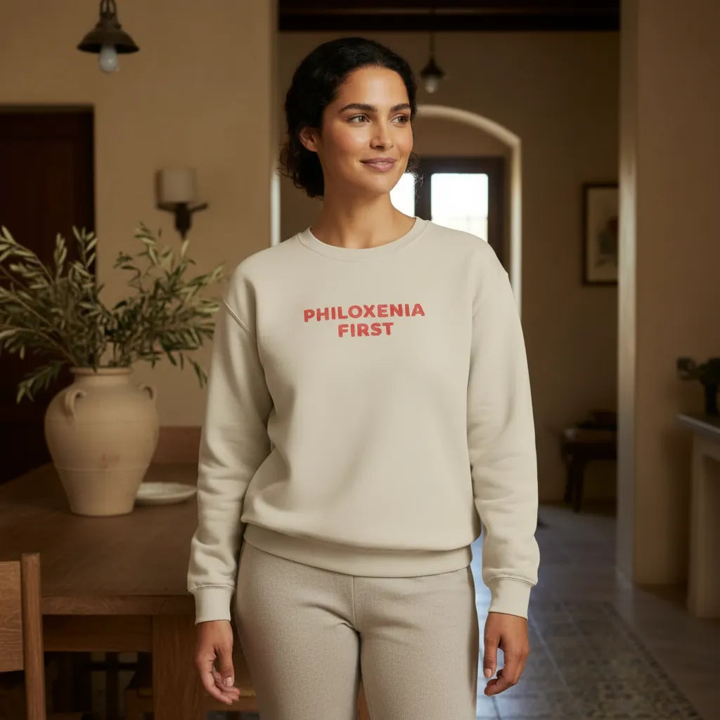 Philoxenia First Greek hospitality embroidered sweatshirt styled in a welcoming Mediterranean home interior